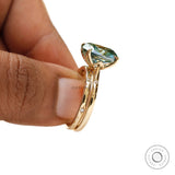 Luxury blue green moissanite ring set with starburst detail and gold band