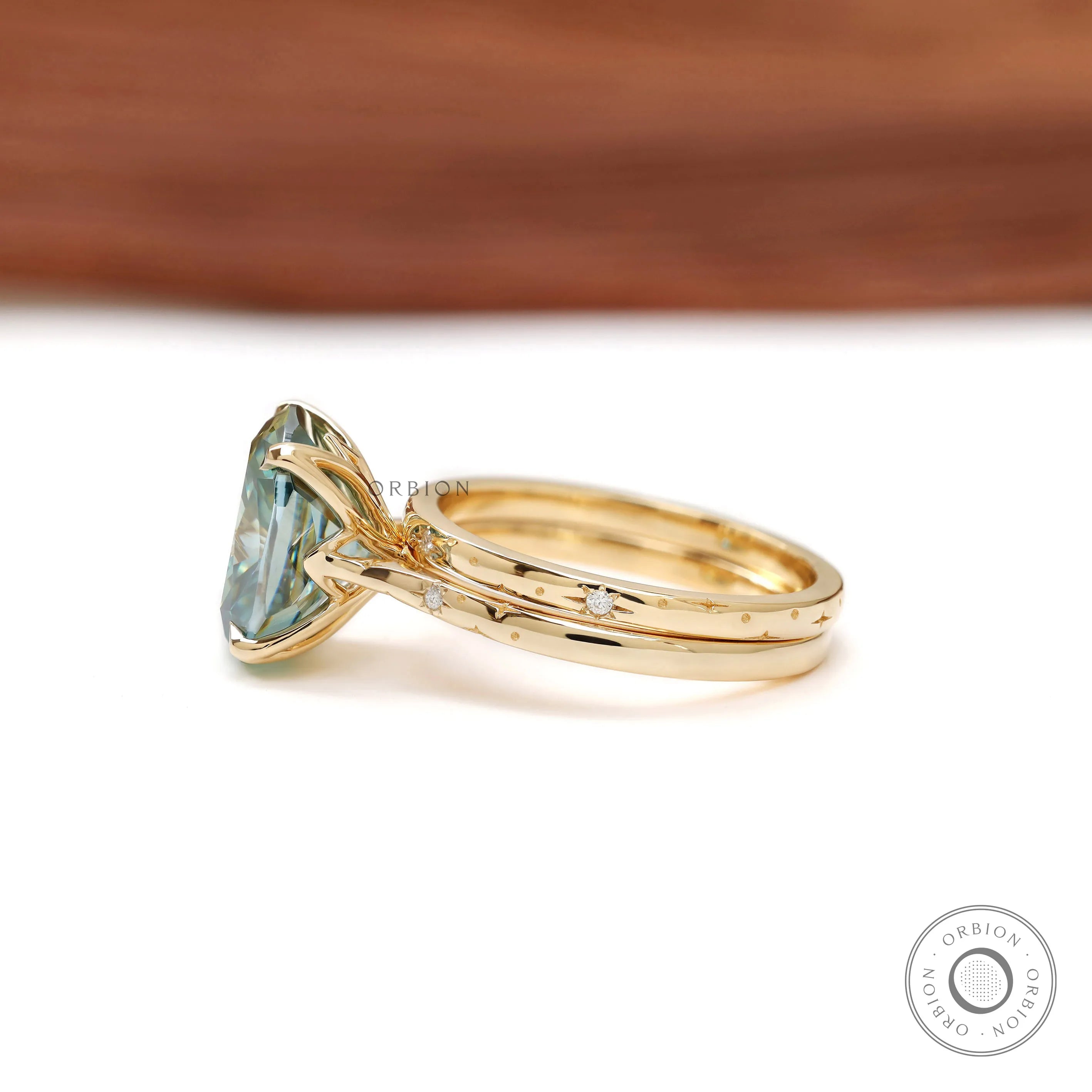 18k Yellow gold starburst ring set with blue green moissanite center stone