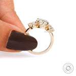 Three stone cushion ring with round brilliant accents
