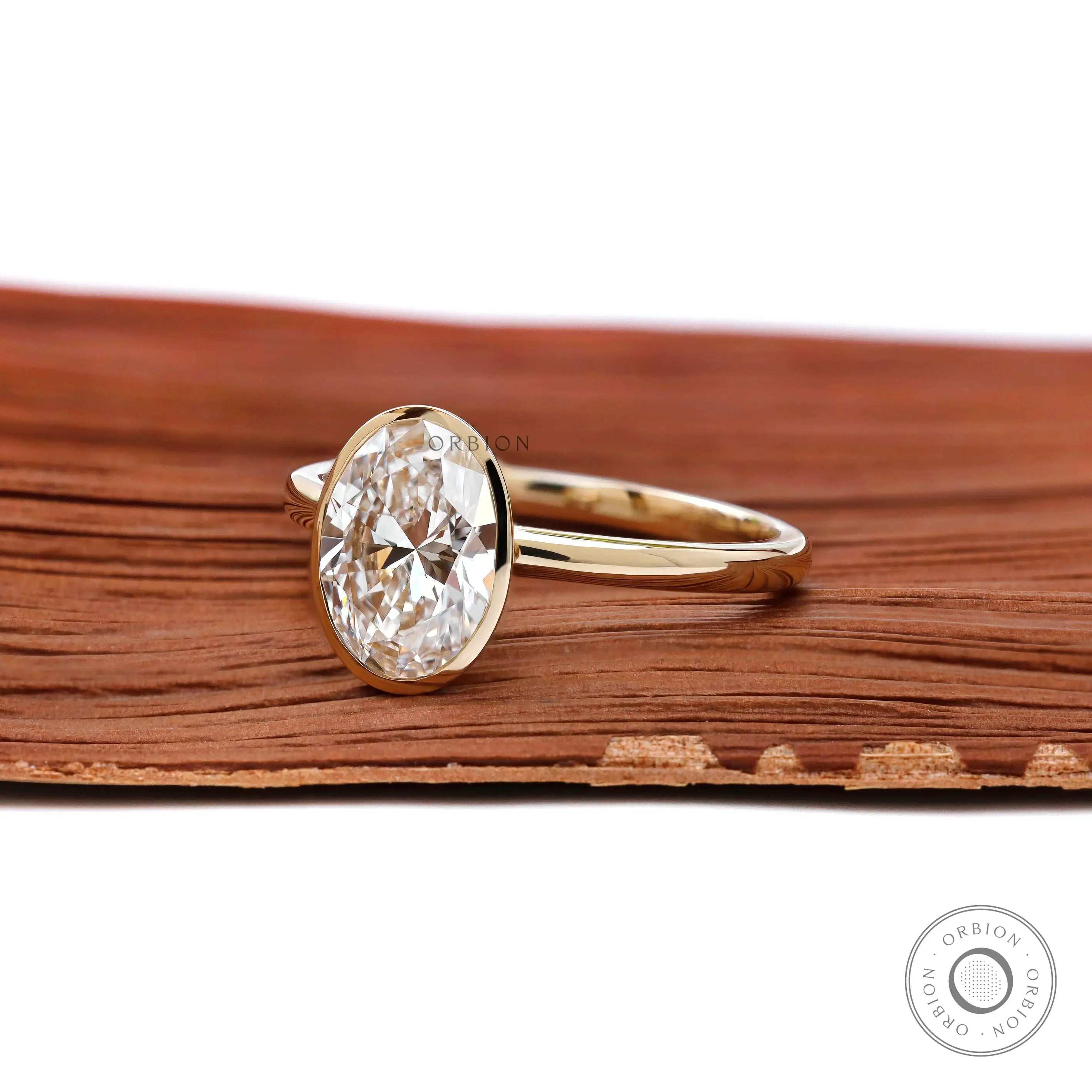 Minimalist oval solitaire engagement ring side profile in yellow gold 