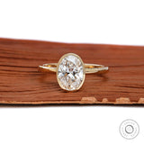 Oval cut bezel set lab diamond engagement ring in 14k yellow gold front view