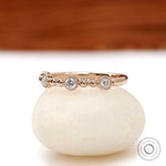 Art Deco stacking ring with milgrain bezel set round stones in rose gold side profile
