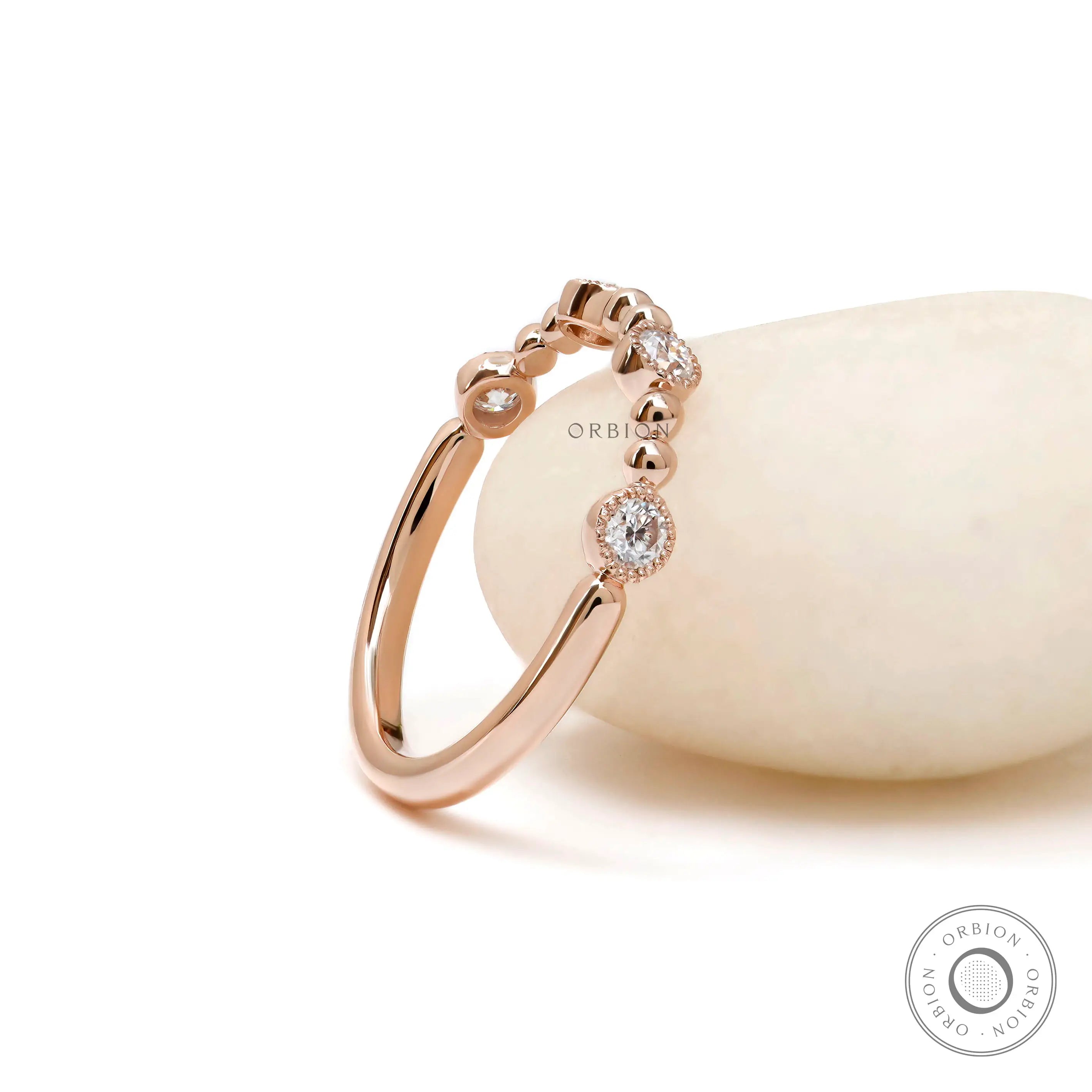 Beaded ball rose gold wedding band with round moissanite close up detail 