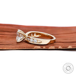 Modern yellow gold engagement ring with channel accents
