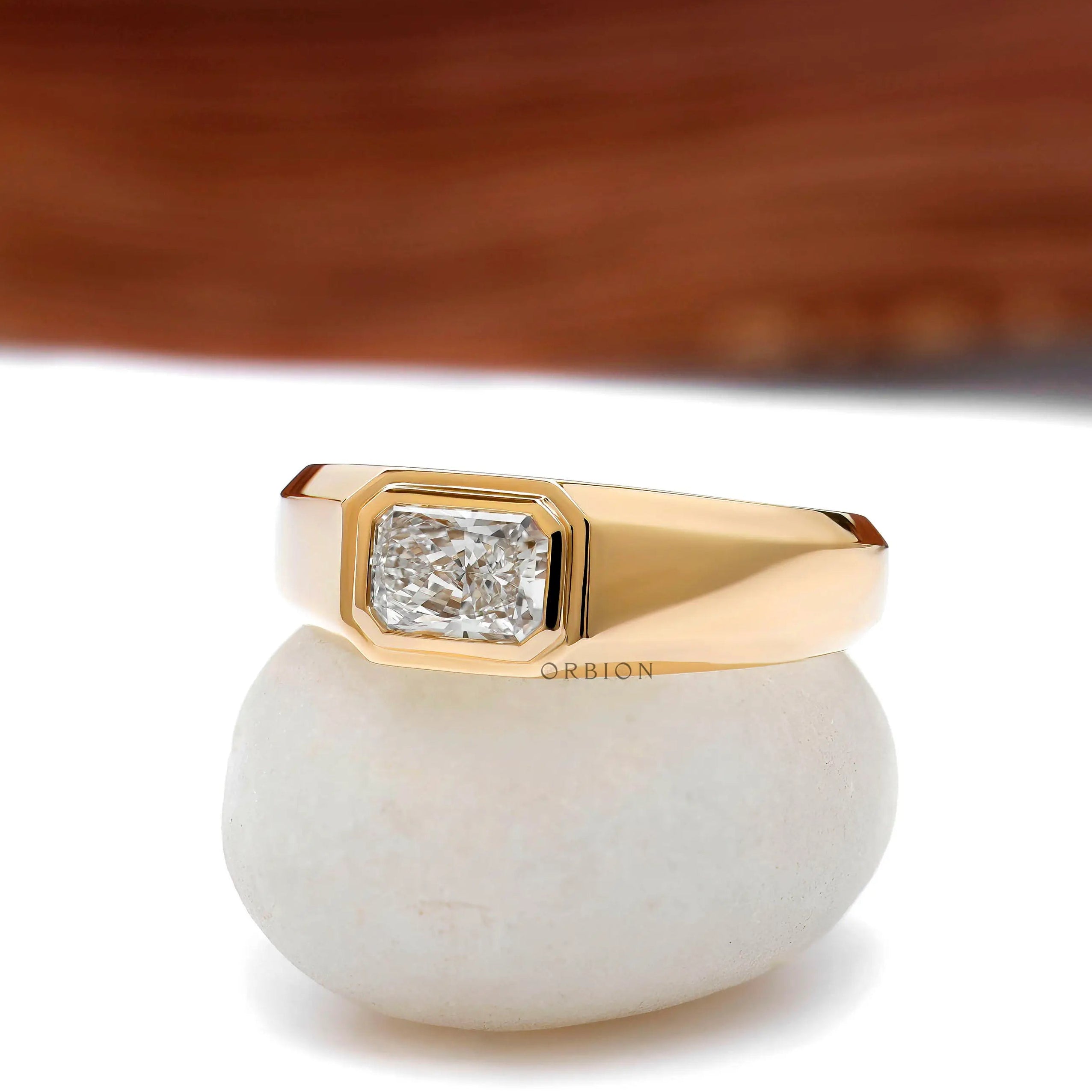 Side view of east west bezel set radiant lab diamond mens yellow gold ring