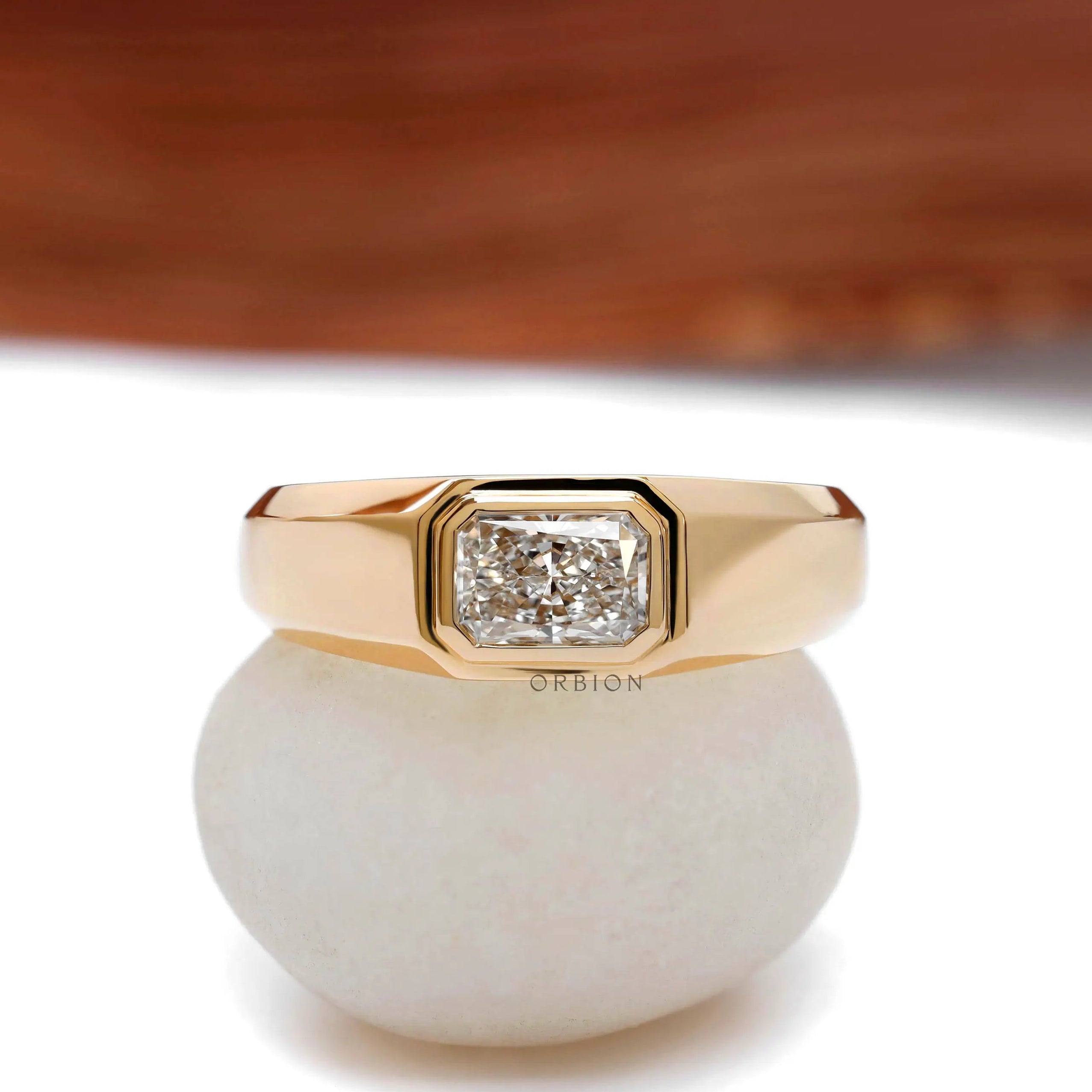 Close up of radiant cut bezel set mens signet ring
