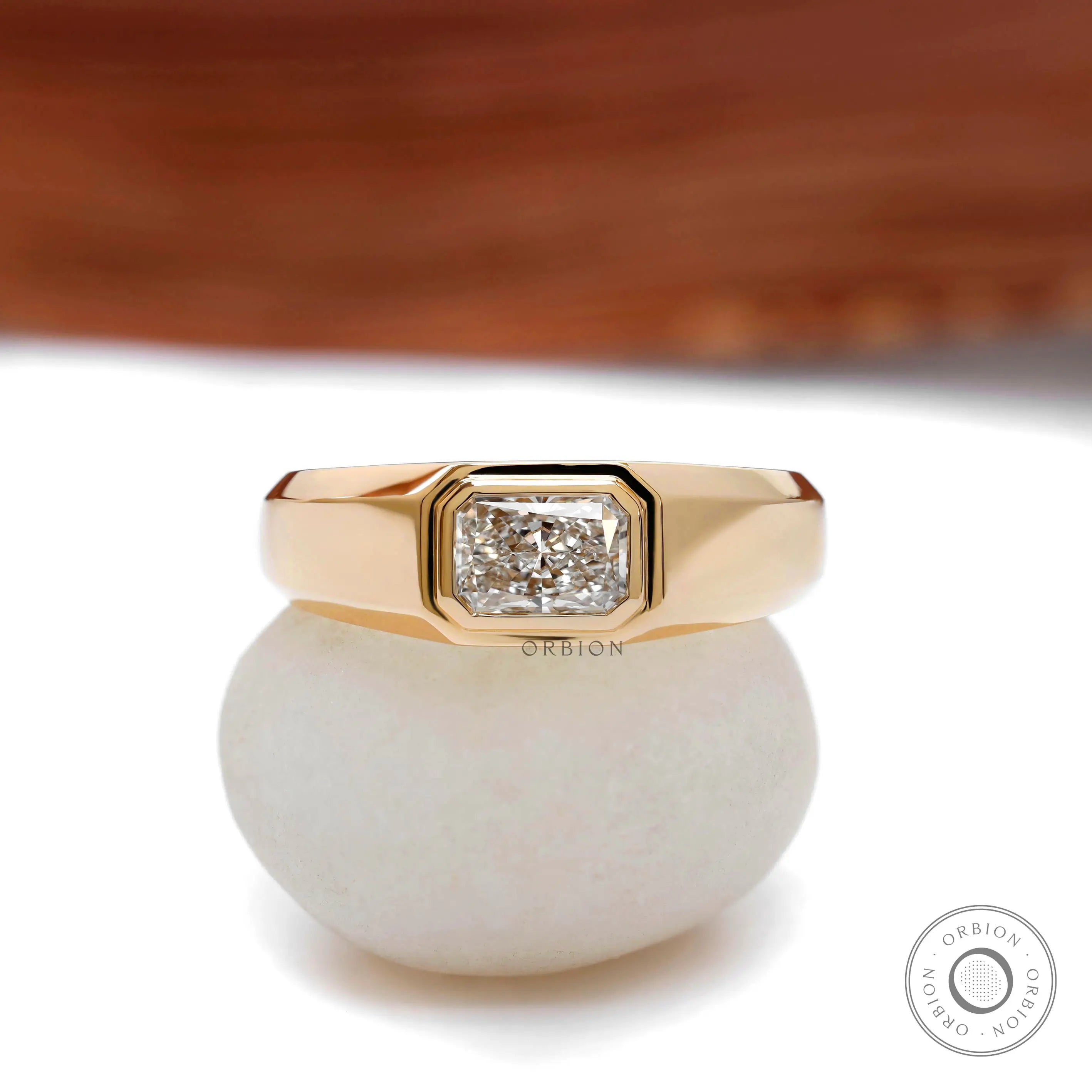 Close up of radiant cut bezel set mens signet ring