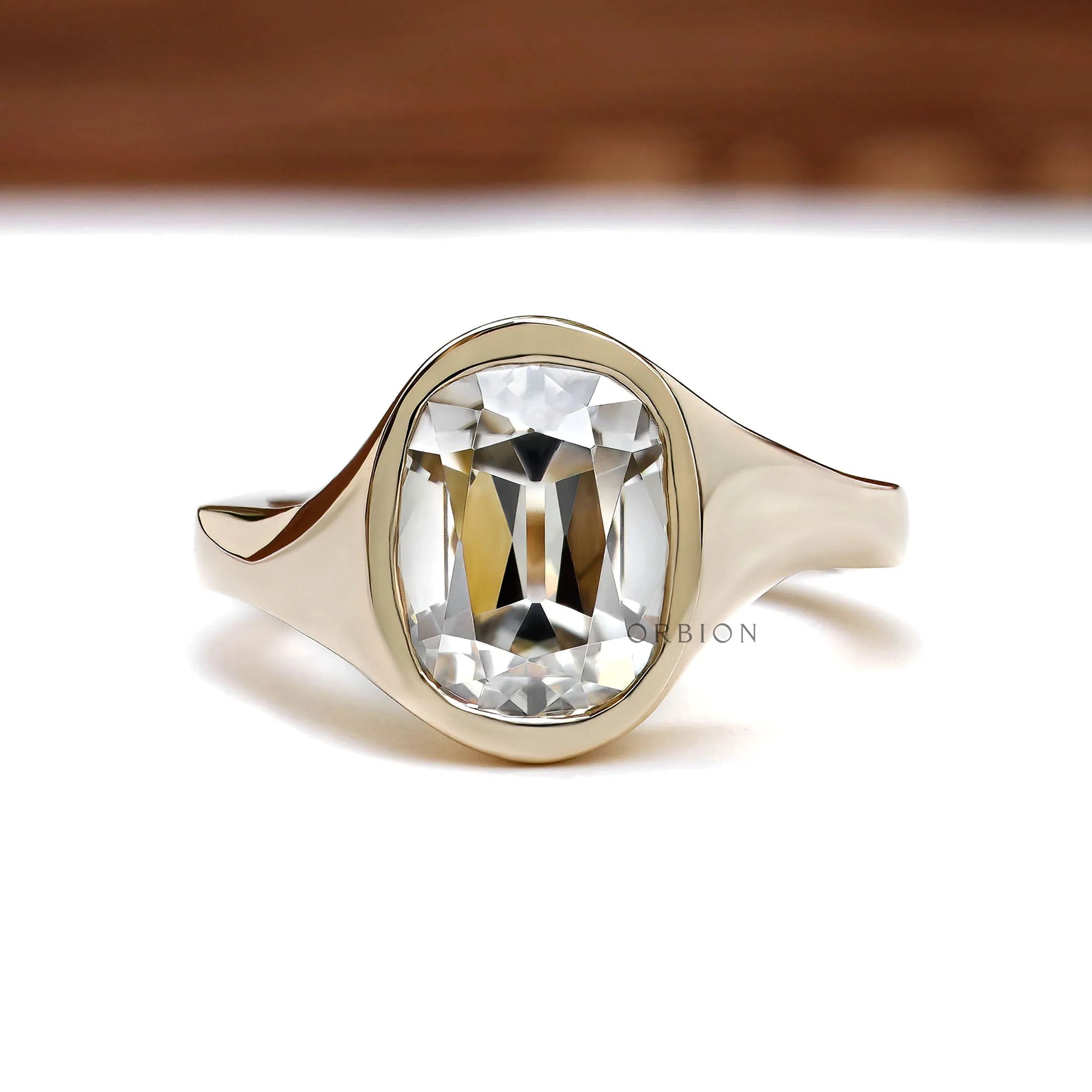 Old mine cut elongated cushion bezel engagement ring in 14k yellow gold