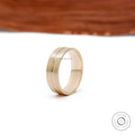 7mm wide gold wedding ring worn on hand side angle view