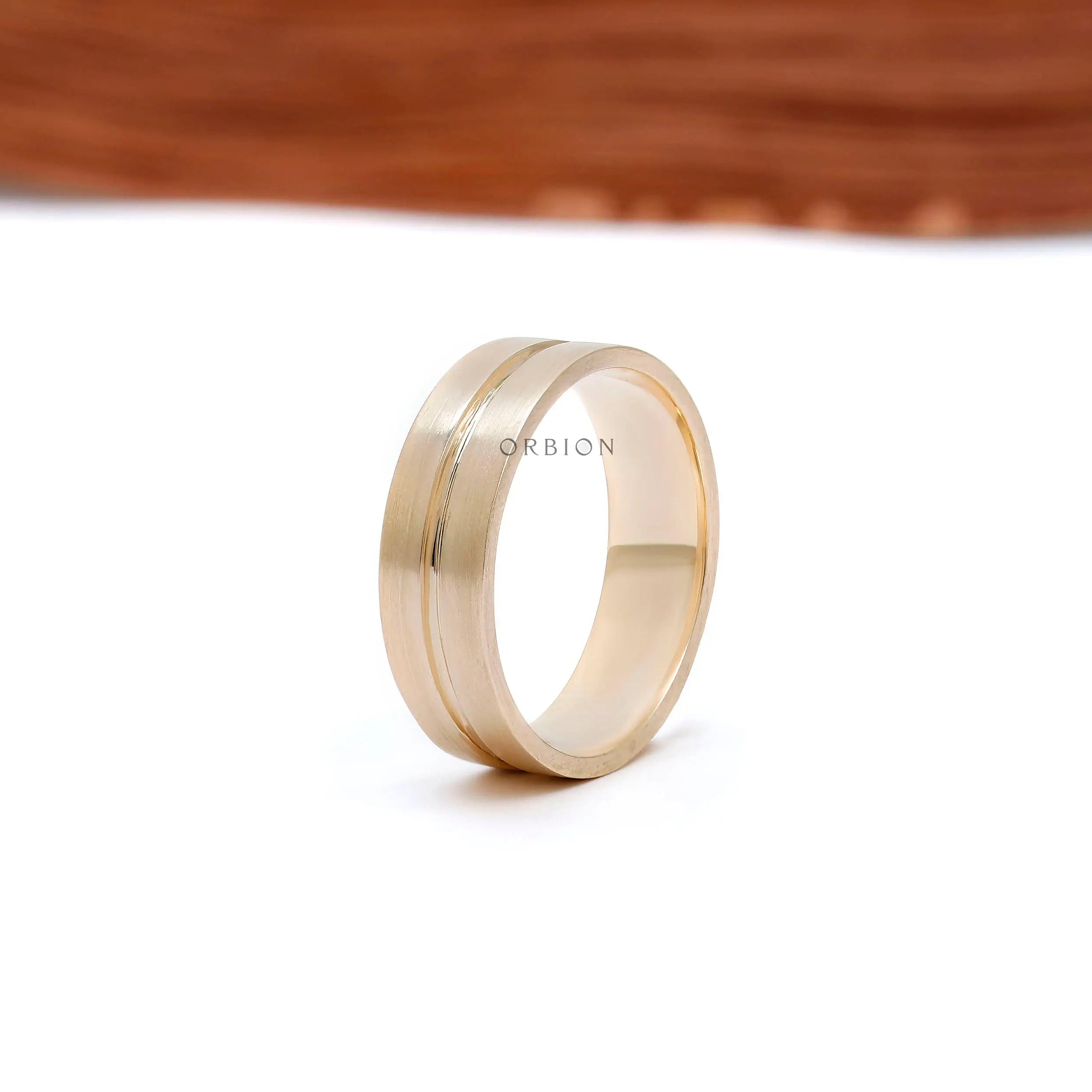 7mm wide gold wedding ring worn on hand side angle view