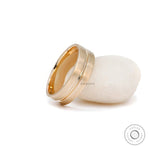 Men’s satin finish gold band with groove detail close up