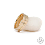 Men’s satin finish gold band with groove detail close up