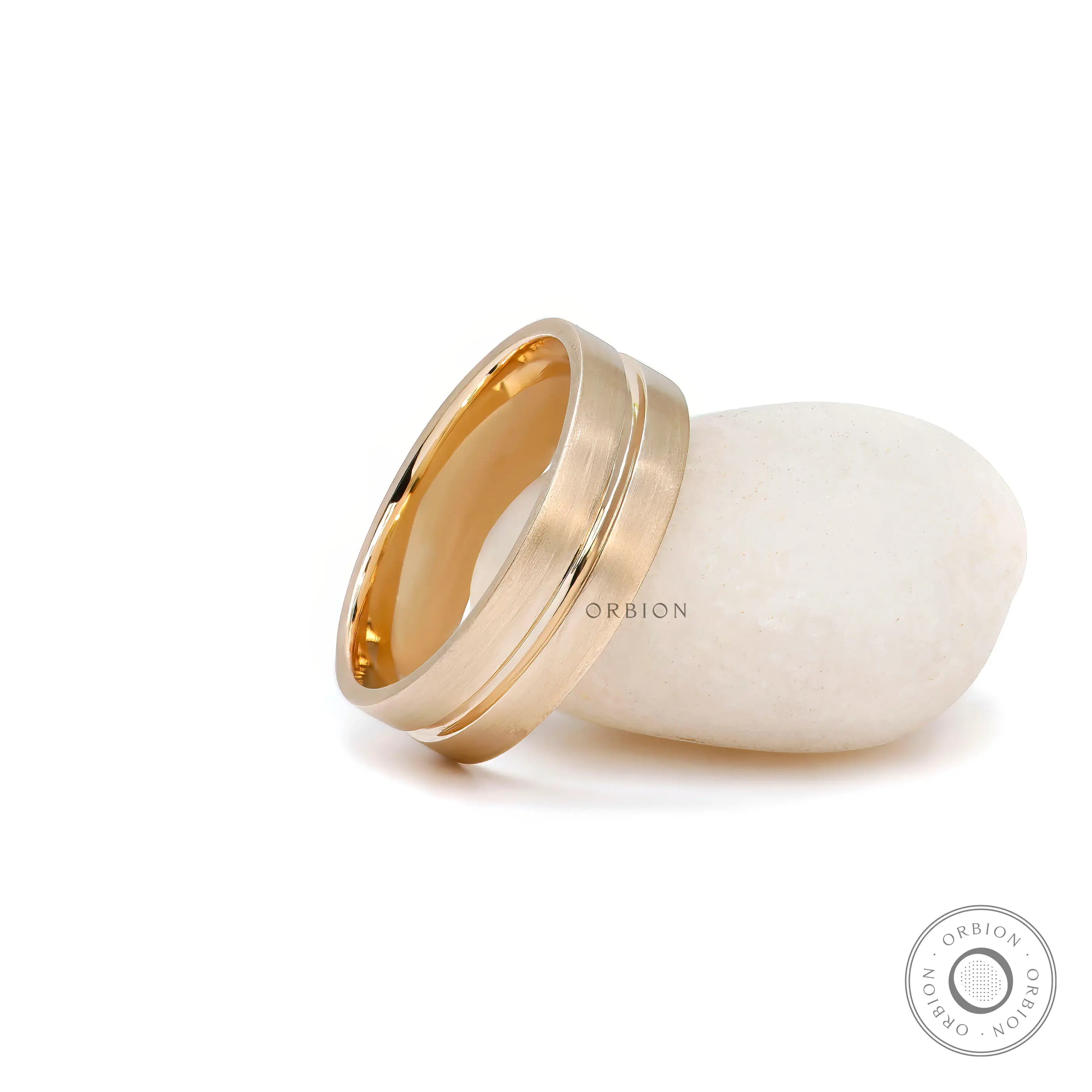 Men’s satin finish gold band with groove detail close up