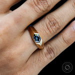 Close up of mens blue moissanite signet ring yellow gold