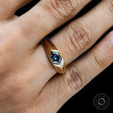 Close up of mens blue moissanite signet ring yellow gold