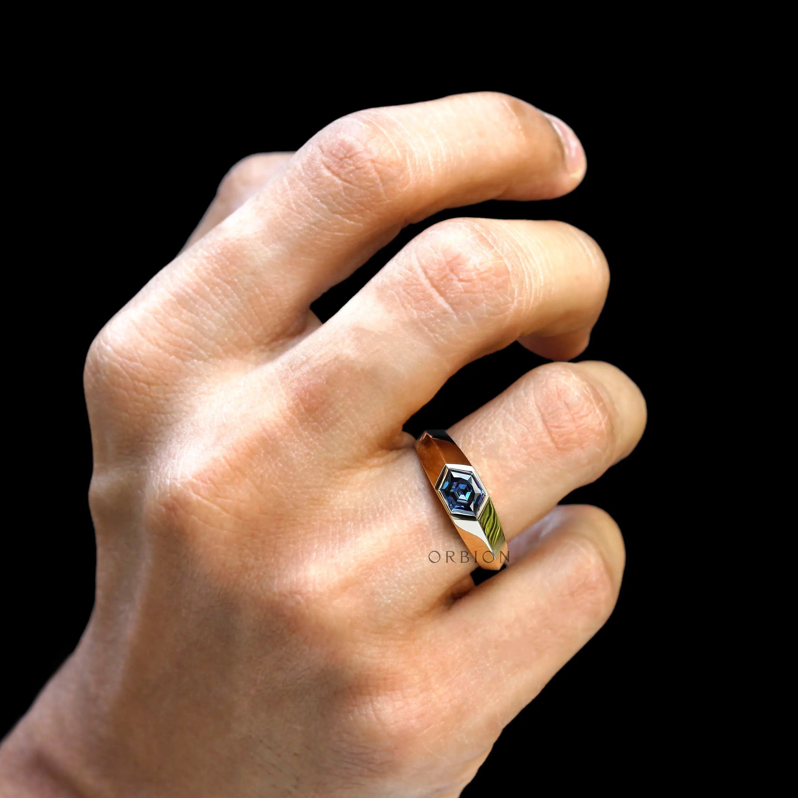  Bezel set hexagon moissanite in yellow gold worn on hand