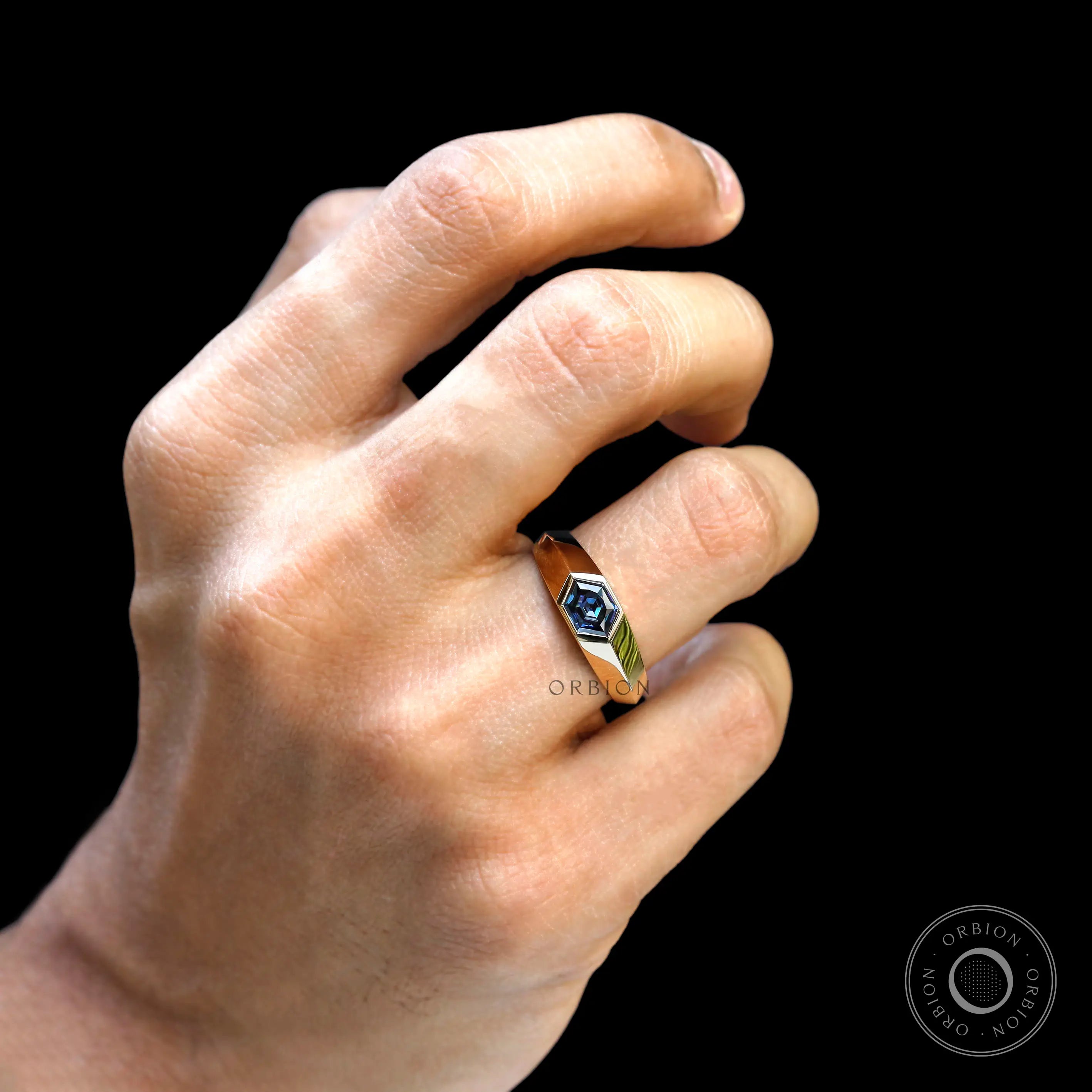  Bezel set hexagon moissanite in yellow gold worn on hand