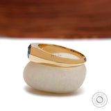 Side profile of men’s tapered gold band with hexagon bezel stone