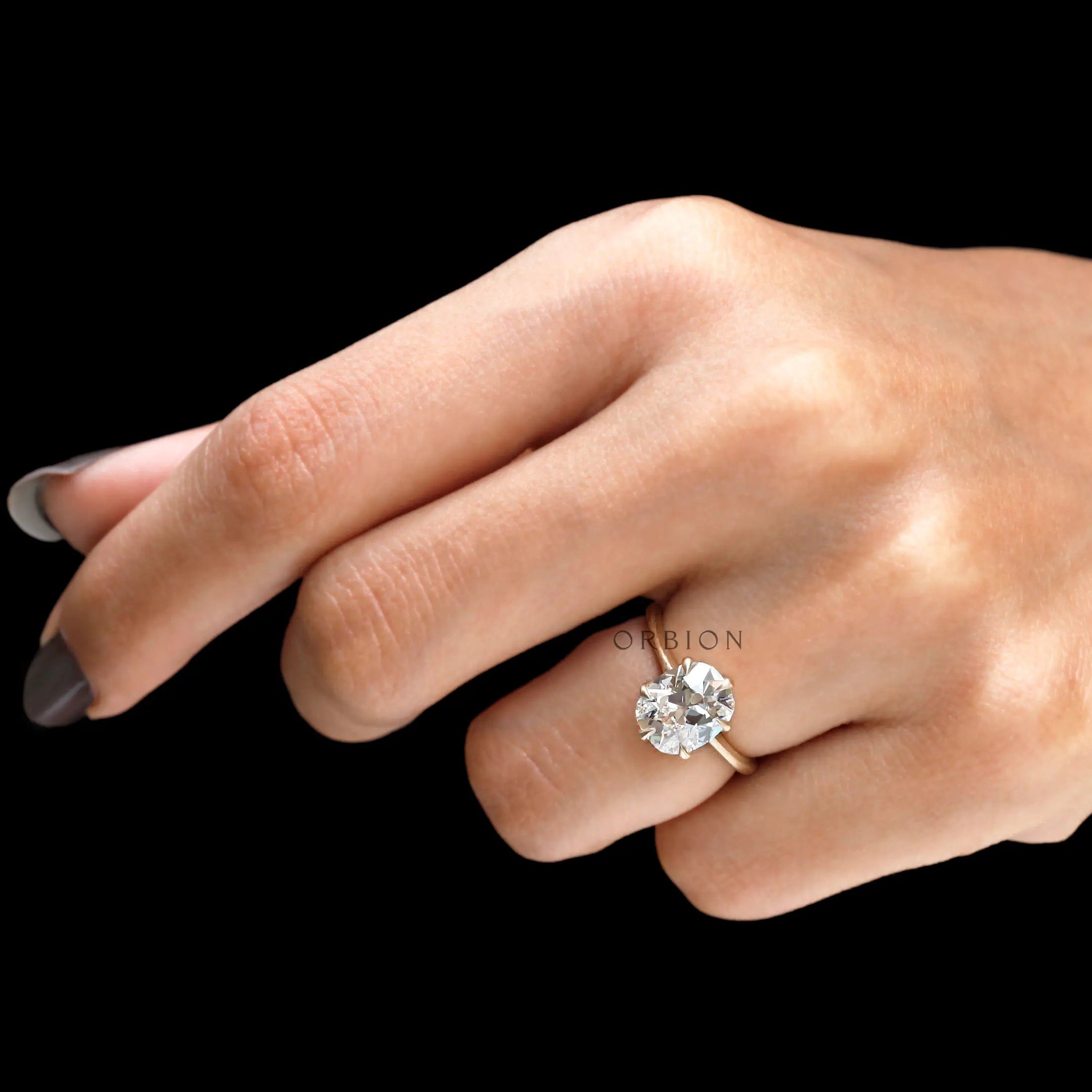 Elegant old mine cut moissanite ring on finger