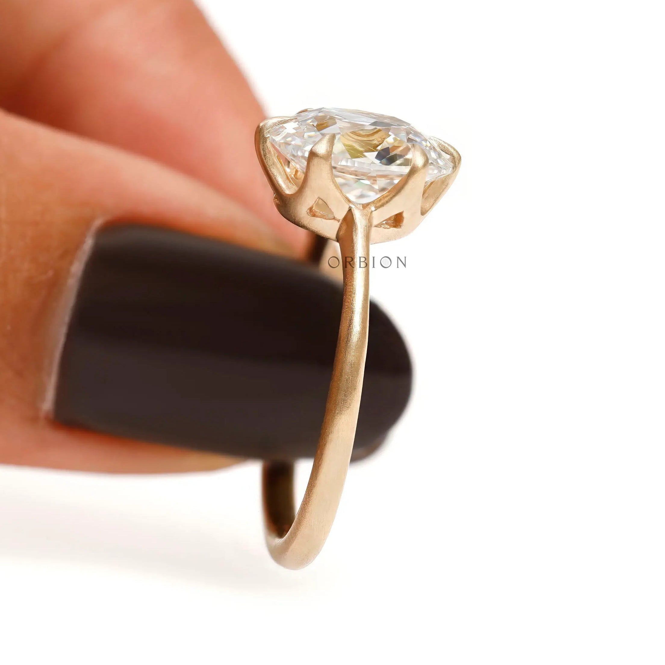 Four prong elongated cushion engagement ring