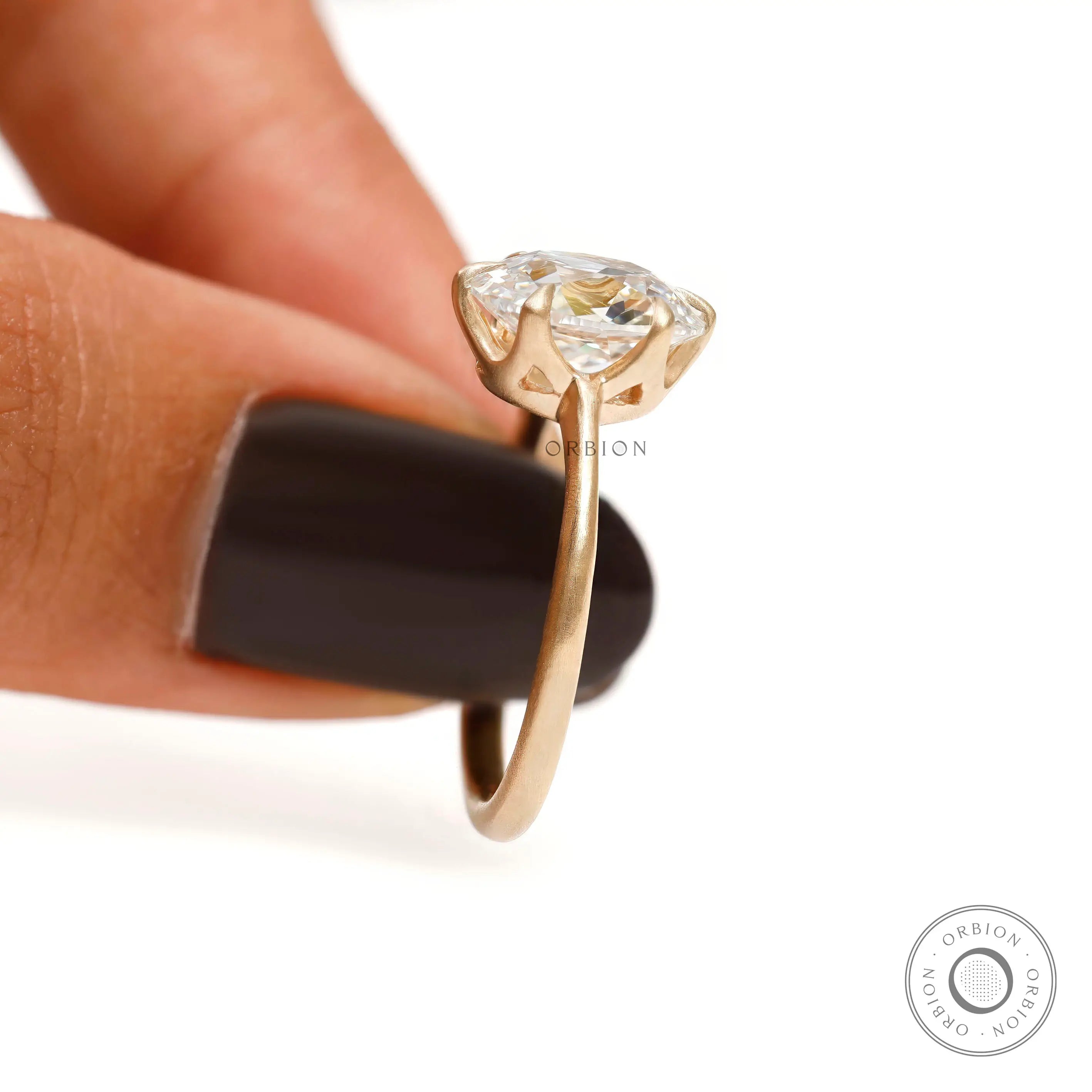 Four prong elongated cushion engagement ring