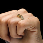 Close up of yellowish champagne moissanite in prong setting