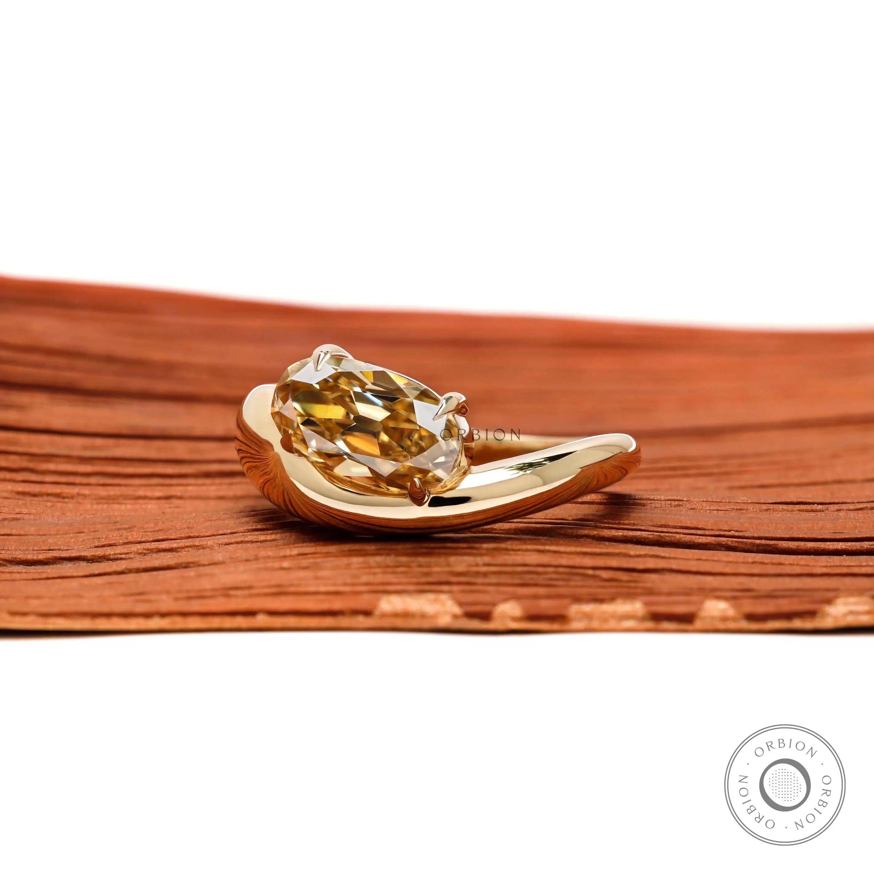 Side profile chunky wave gold engagement ring with oval moissanite
