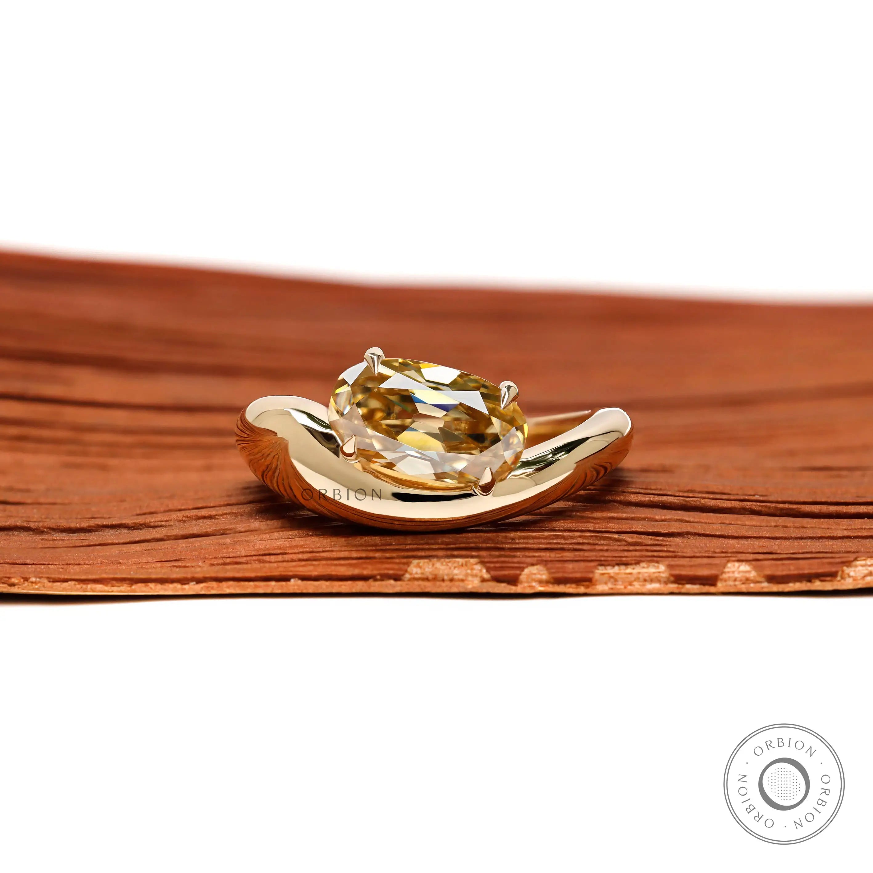 Modern chunky wave oval yellowish champagne moissanite engagement ring in 10K yellow gold front view