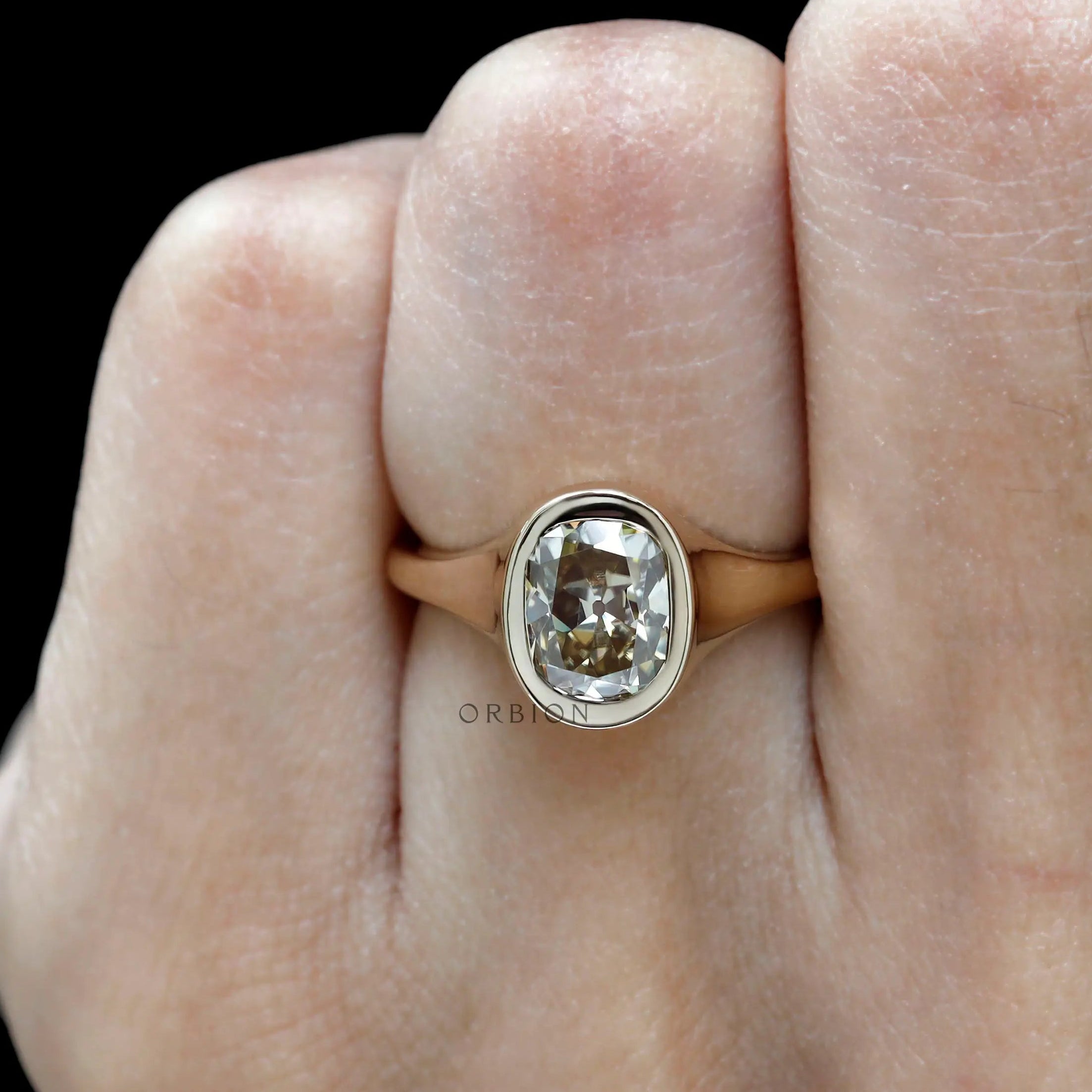 Warm tone champagne moissanite solitaire ring close up