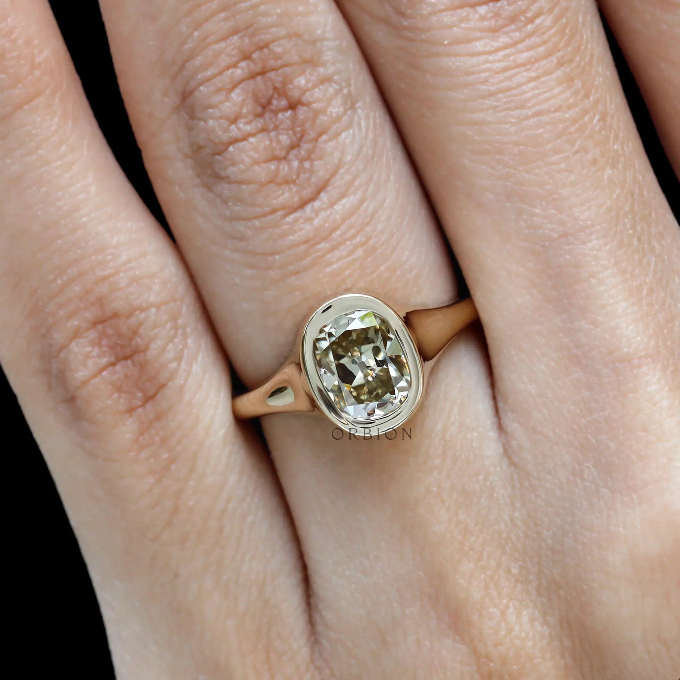 Minimalist signet style moissanite engagement ring on hand