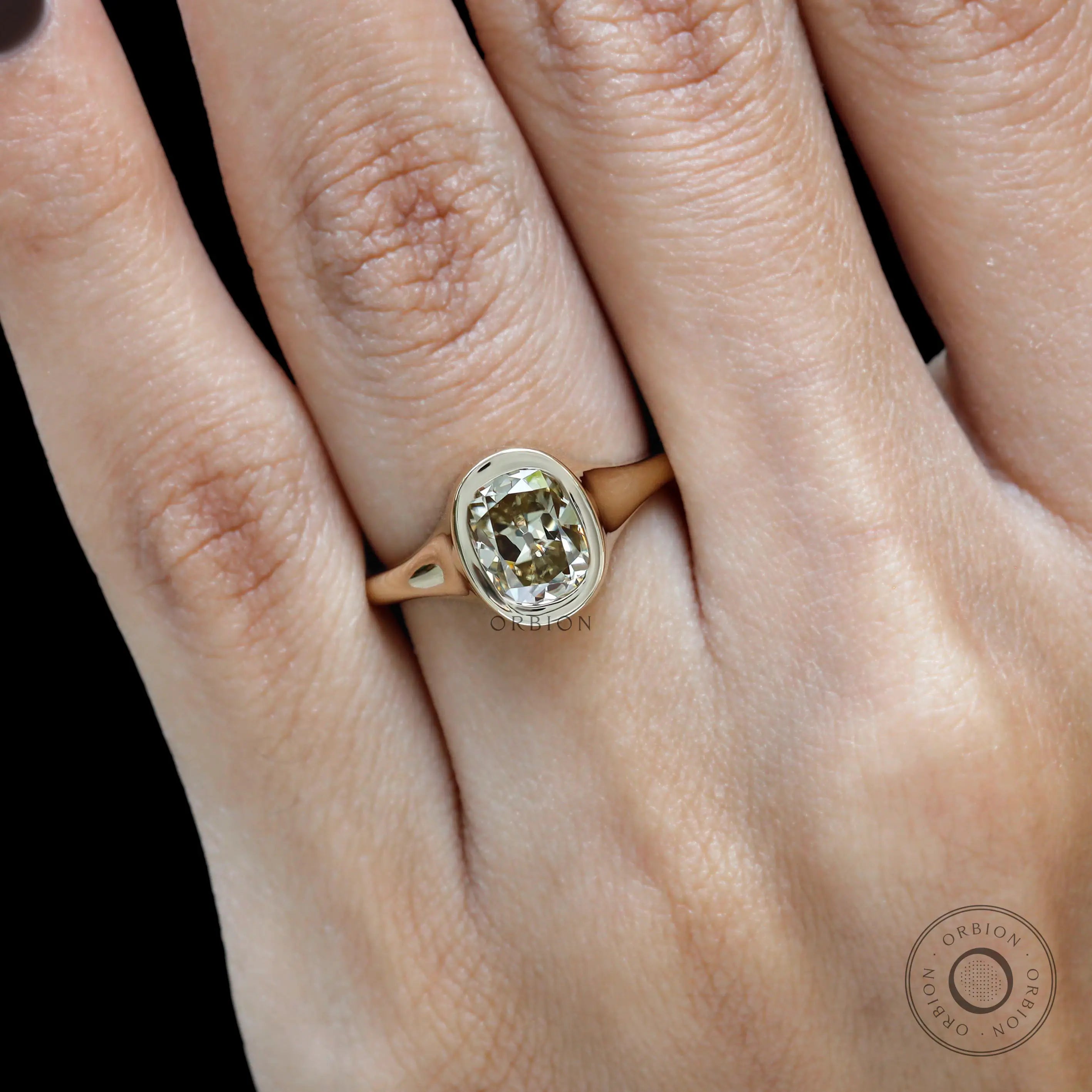 Minimalist signet style moissanite engagement ring on hand