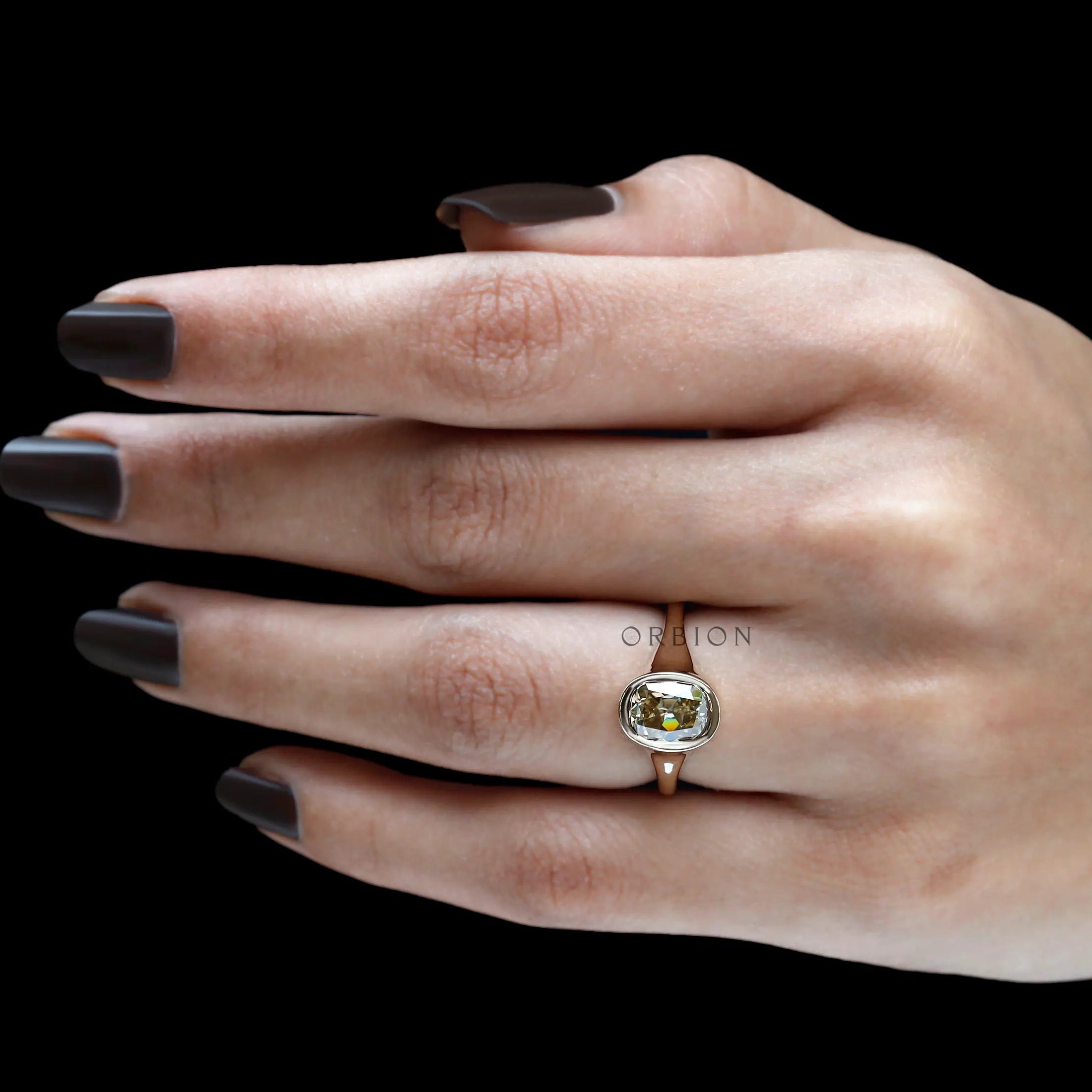 Vintage inspired champagne moissanite ring on finger