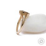 Side view of bezel set cushion champagne moissanite in yellow gold