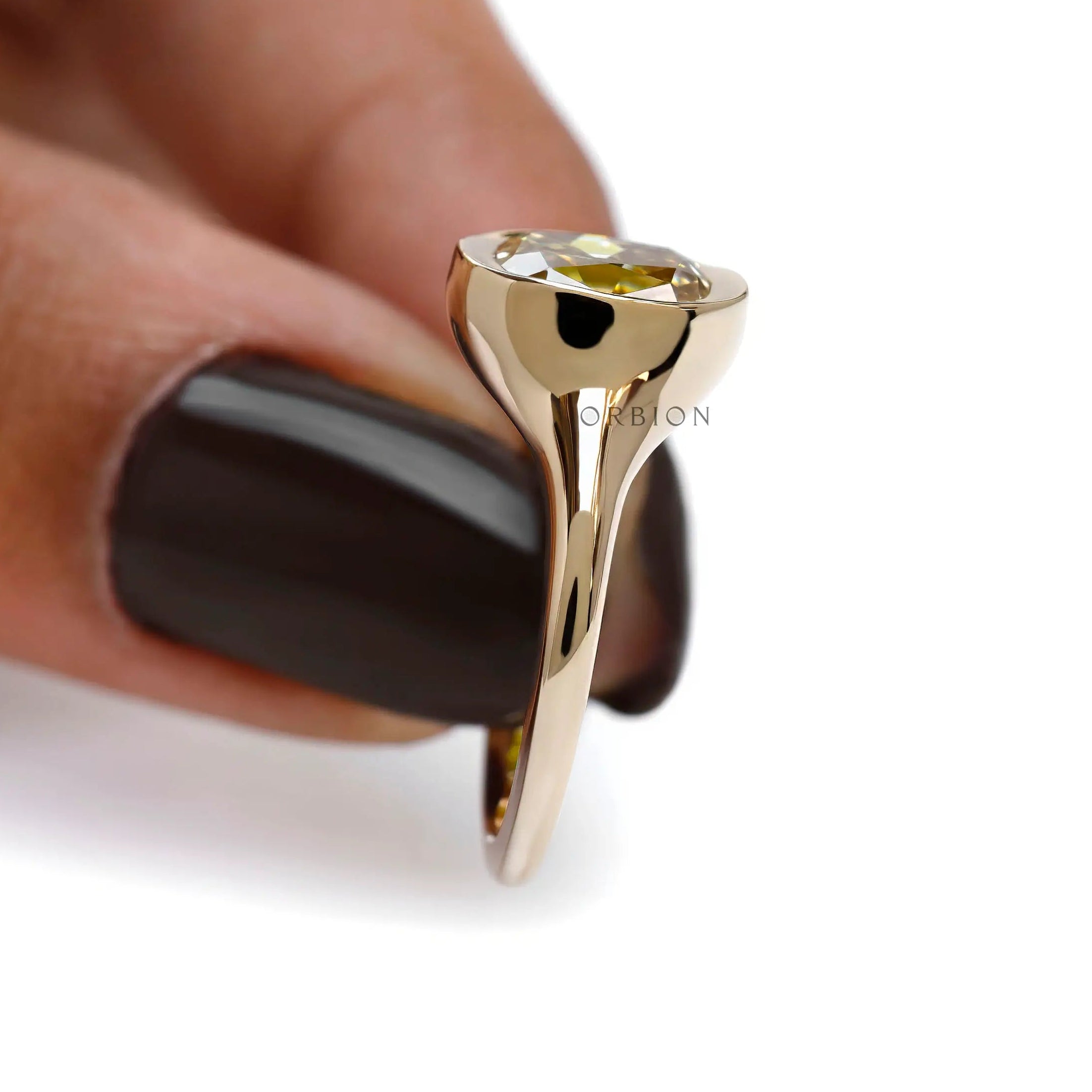 Elongated cushion old mine cut moissanite in smooth bezel