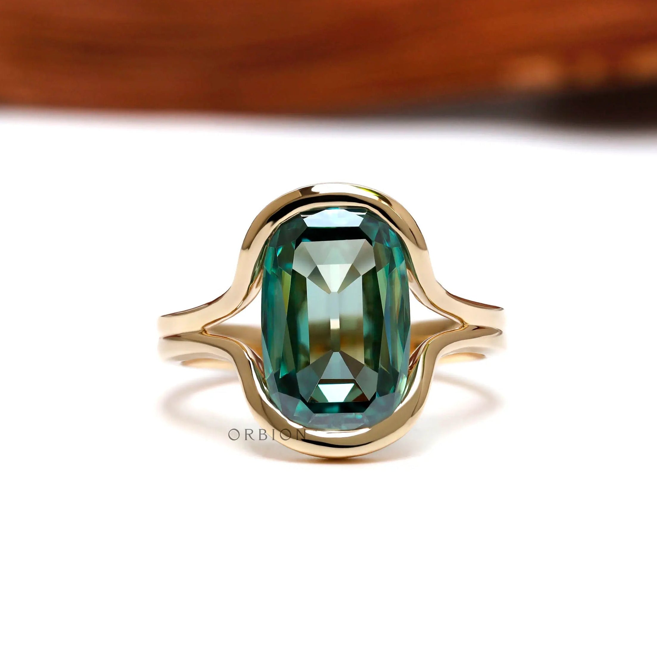 Front view of green moissanite floating half bezel ring