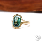Angled front view of elongated green moissanite gold ring