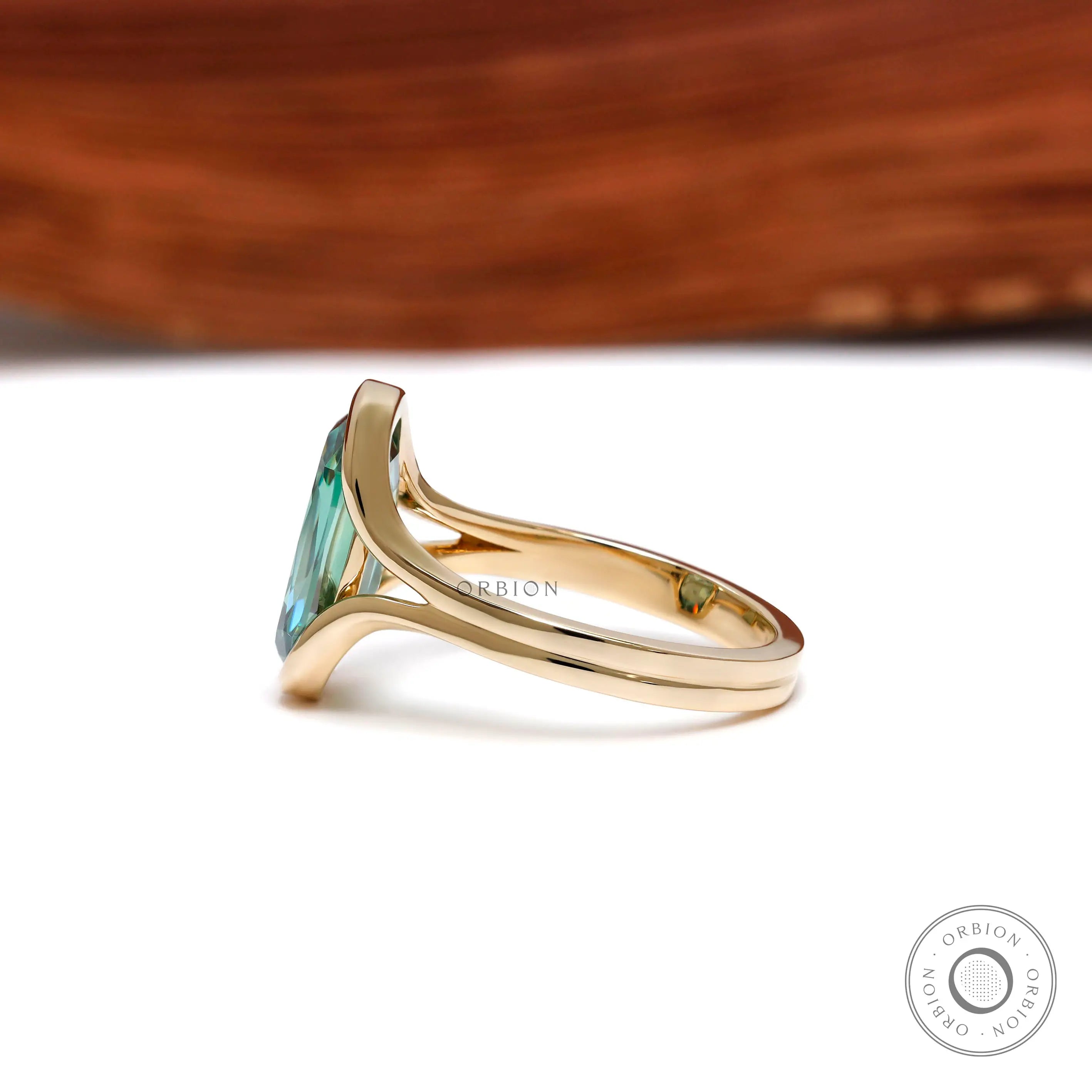 Side view of floating half bezel green moissanite ring