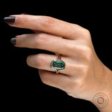 Top worn view of elongated green moissanite bezel ring