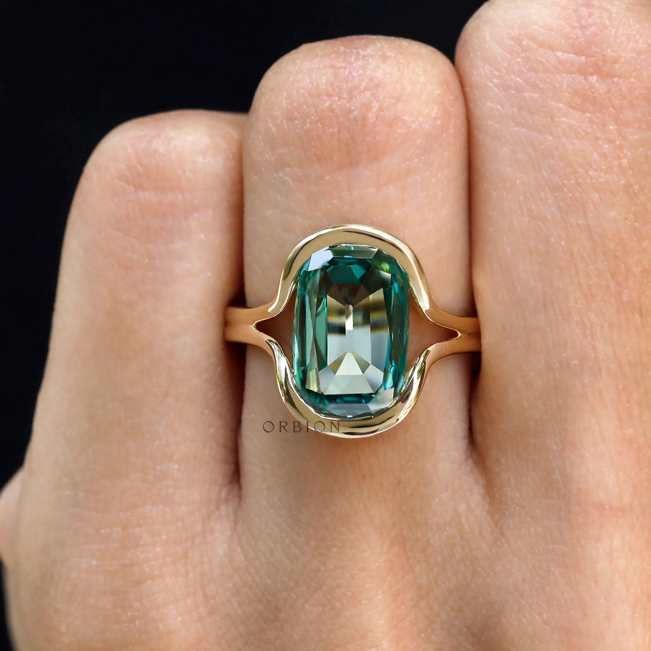 Close-up worn view of green moissanite floating bezel ring
