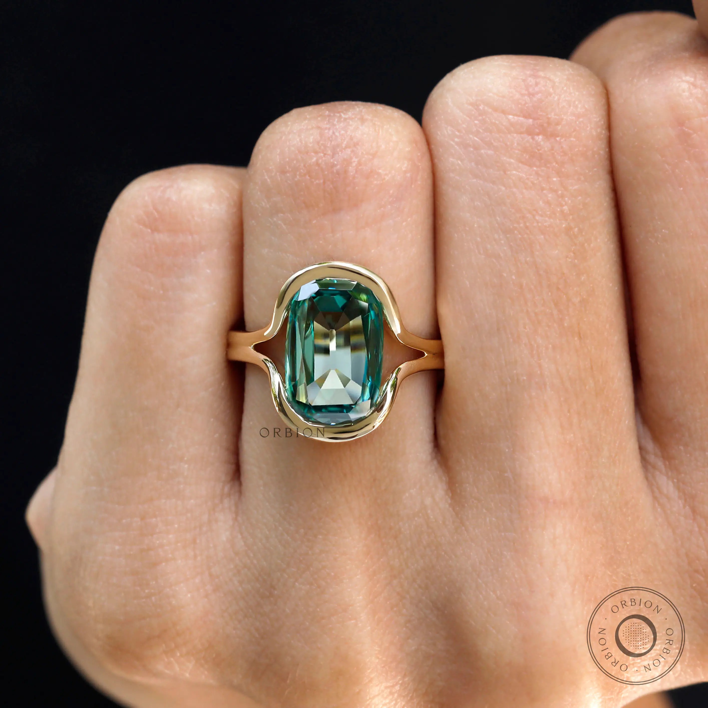 Close-up worn view of green moissanite floating bezel ring