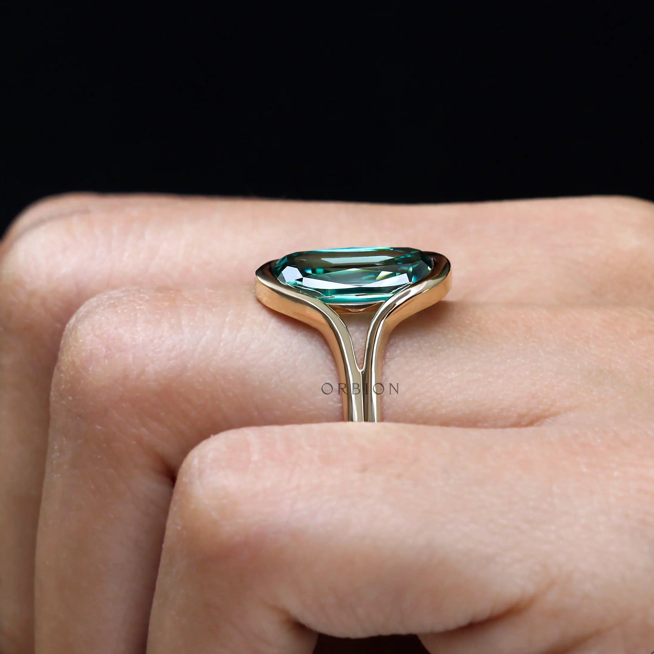 Side worn profile of elongated green moissanite gold ring