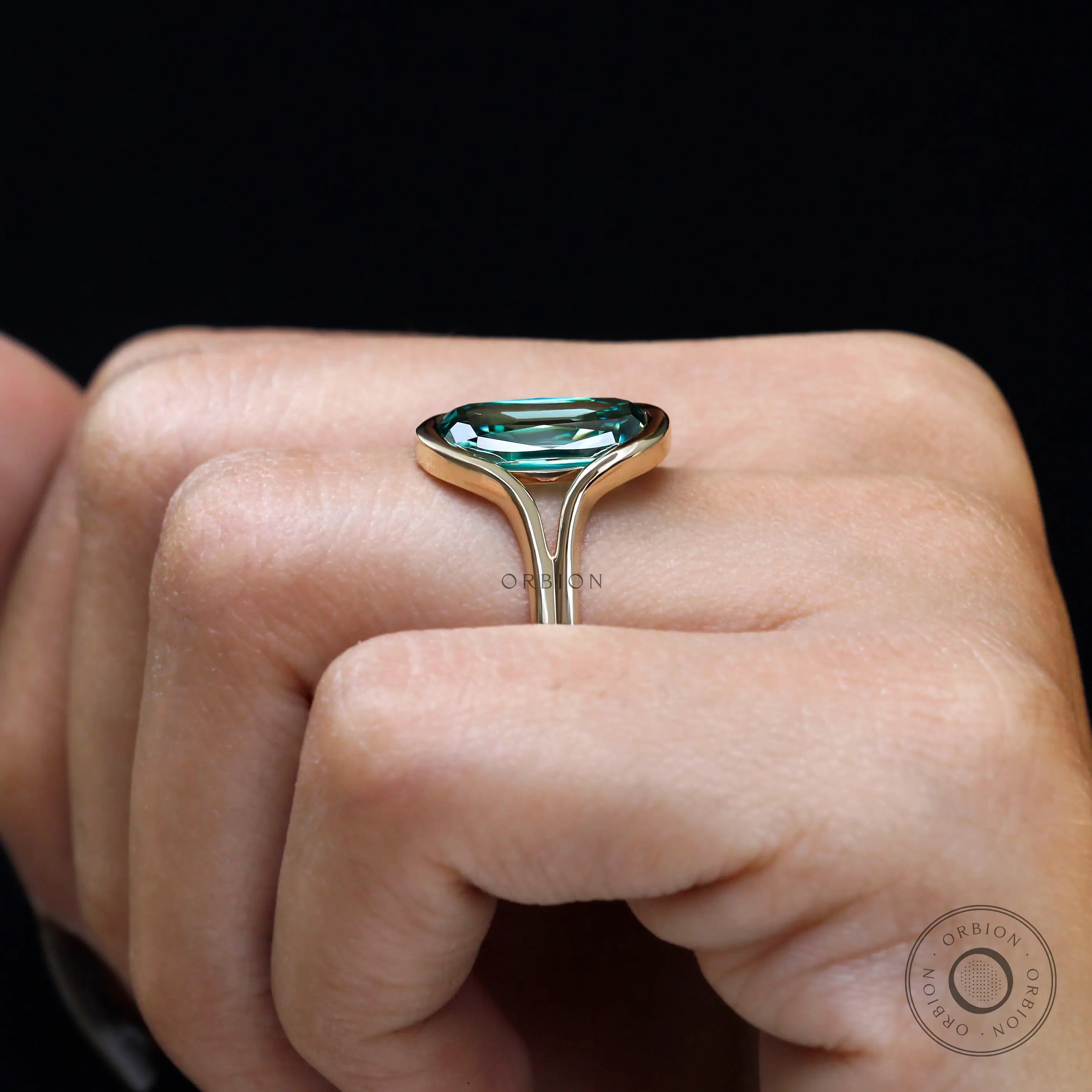 Side worn profile of elongated green moissanite gold ring