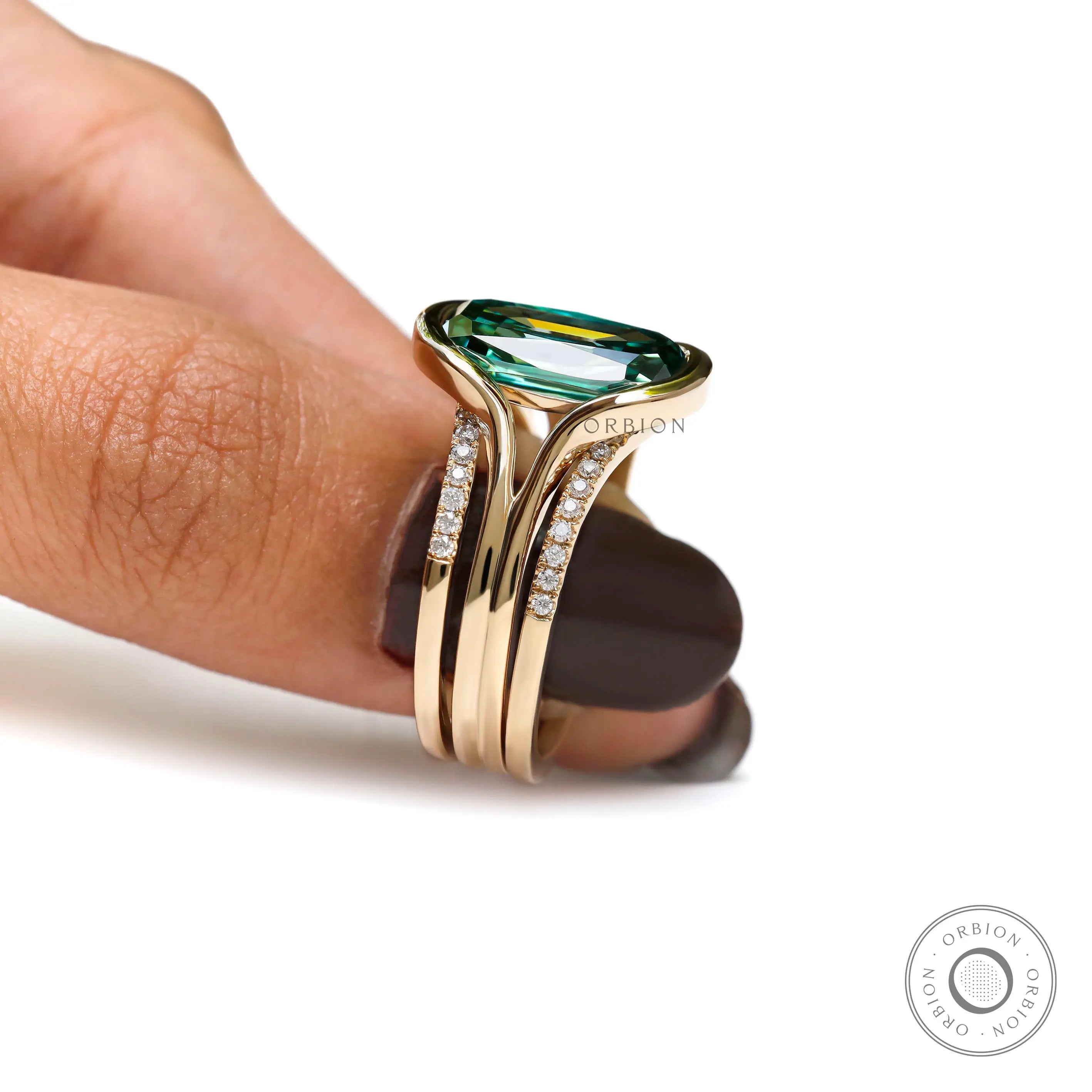 Close-up top view of green moissanite ring set hold on hand