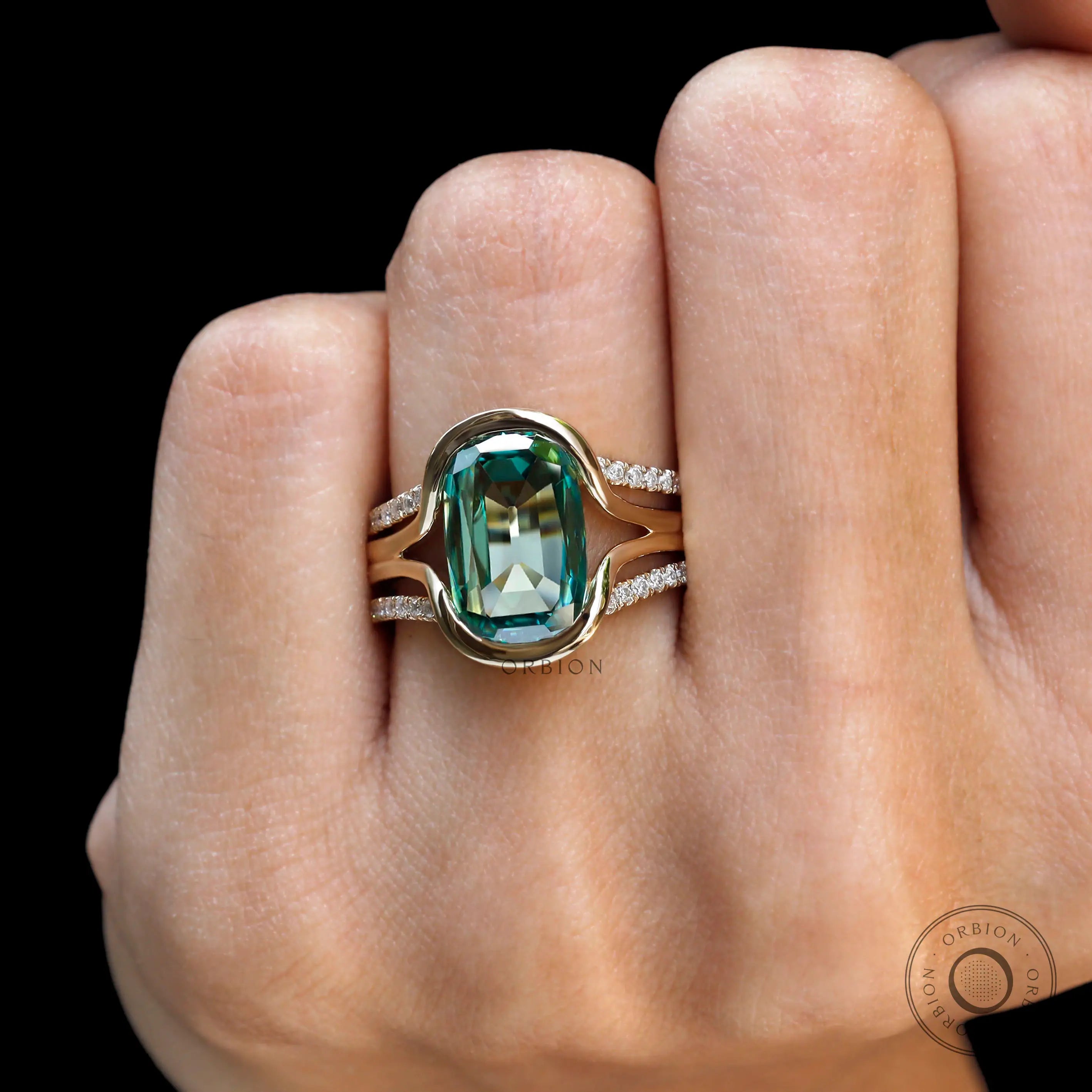 Top view of elongated cushion green moissanite ring set on hand