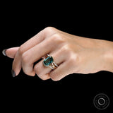 Side close-up of green moissanite ring set worn on finger
