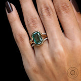 Close view of elongated cushion green moissanite ring set worn on hand