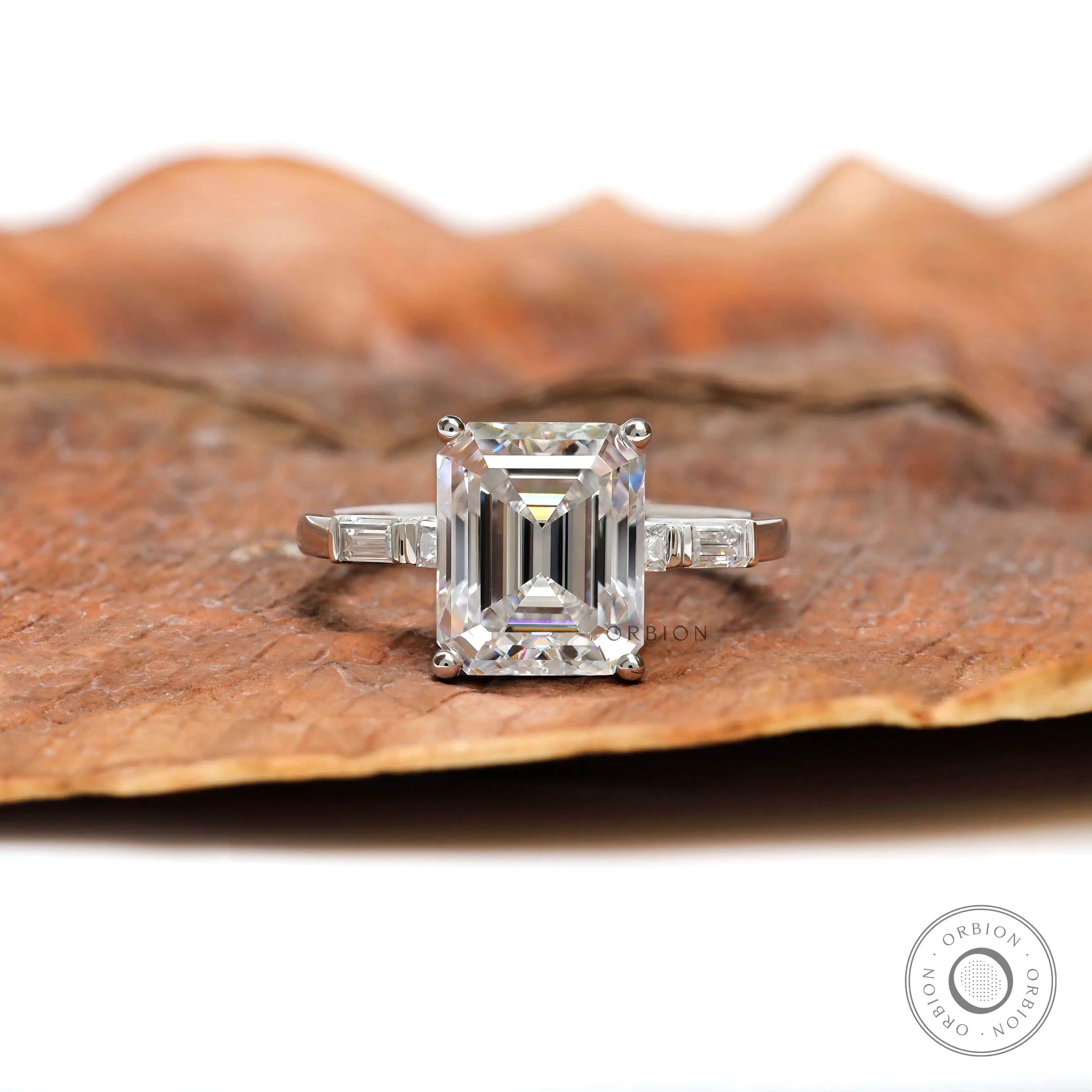 Emerald step cut diamond ring with baguette side stones