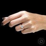 Rose gold OEC round solitaire engagement ring on hand close up