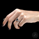 Dark grey gemstone engagement ring on hand