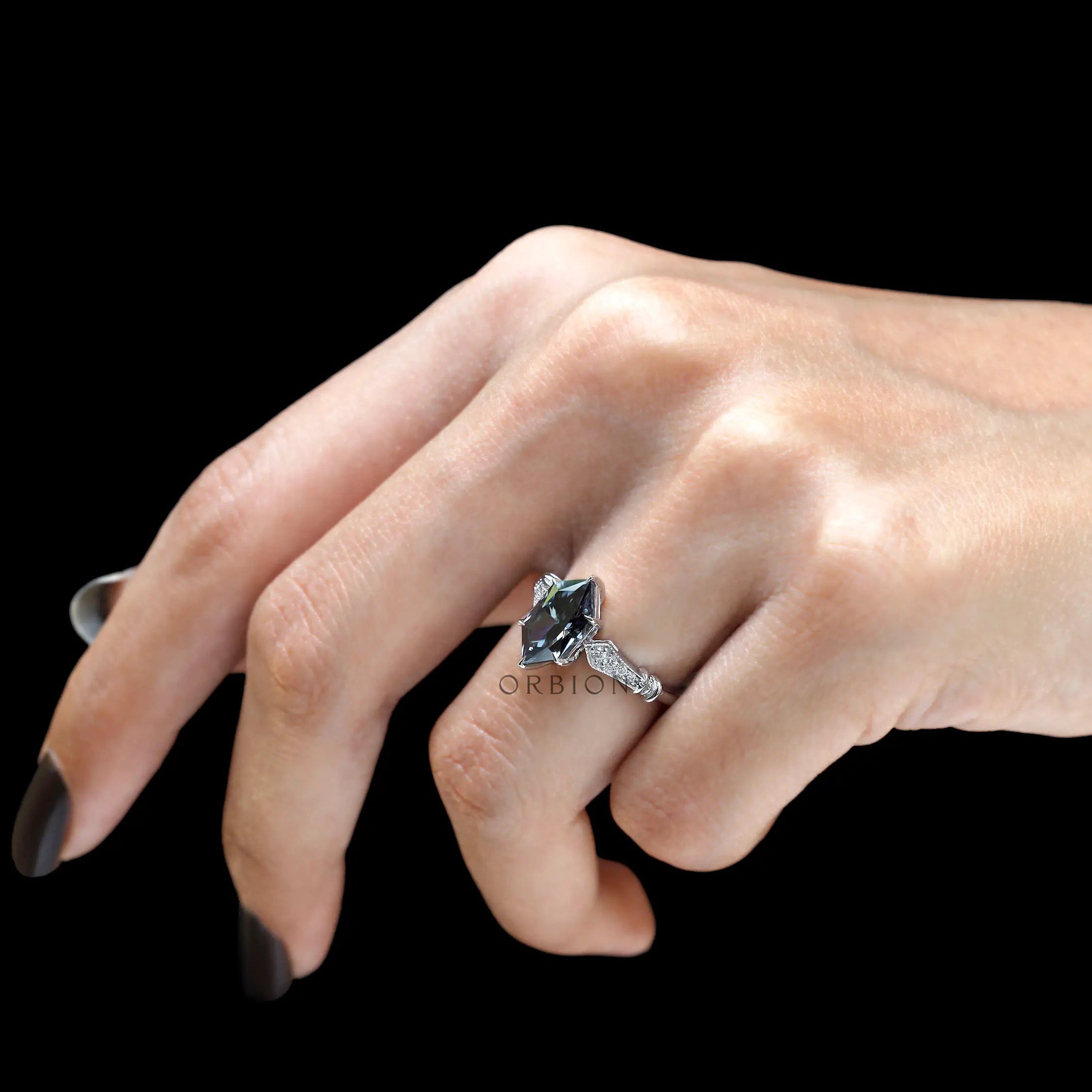 Dark grey gemstone engagement ring on hand